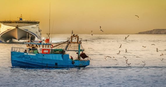 How should you pass a fishing boat?